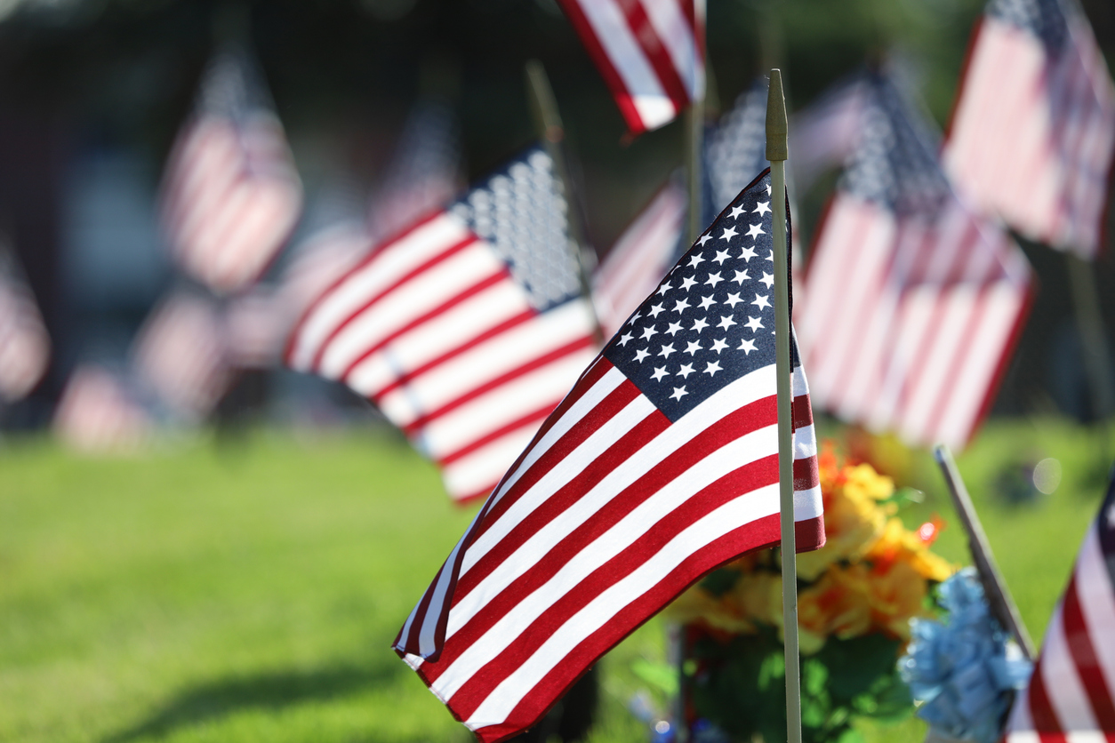 Memorial Day Ceremony, American Flags Flying in Veterans Cemetry